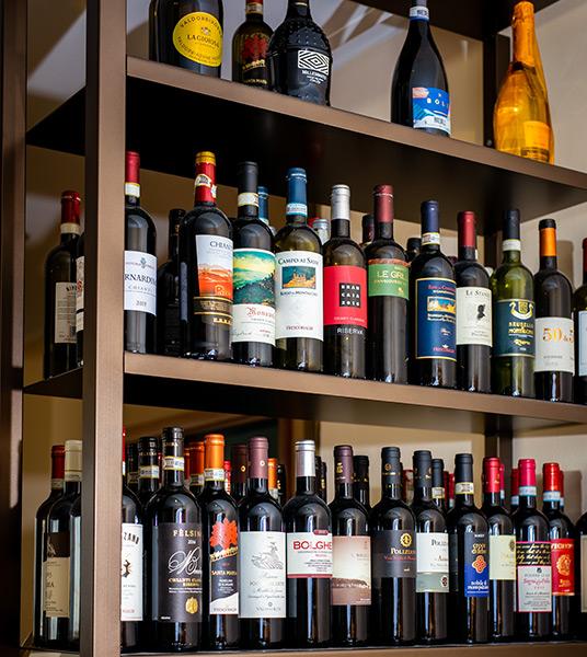 Shelf with displayed red and white wine bottles.